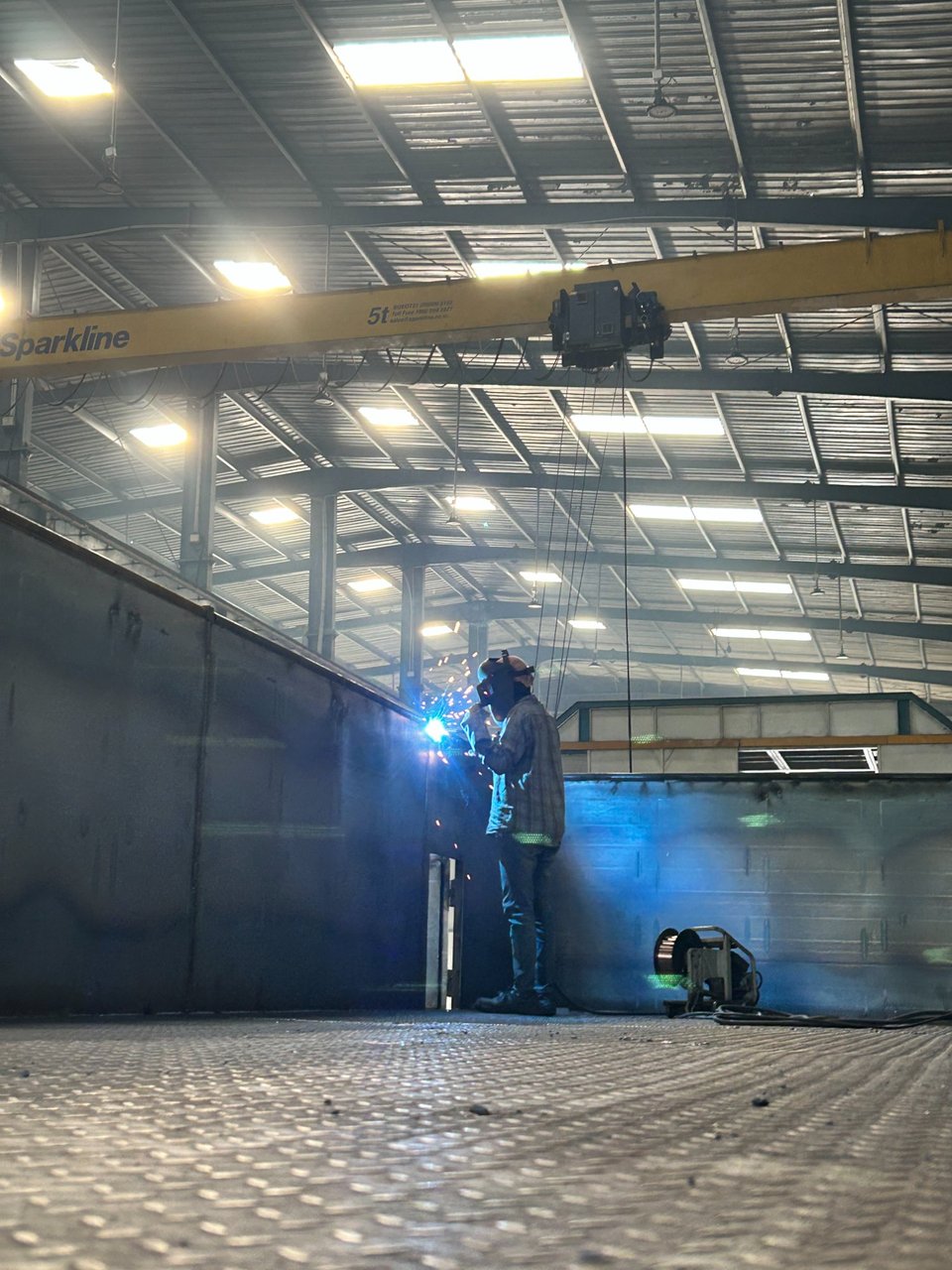 GoldLine Factory welder inside trailer body with overhead crane